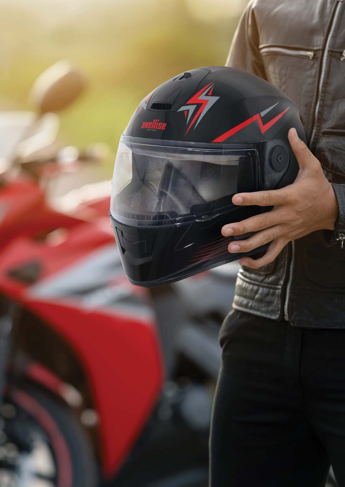 Axellise Thunderbolt helmet in Glossy Black colourway, held by a rider
