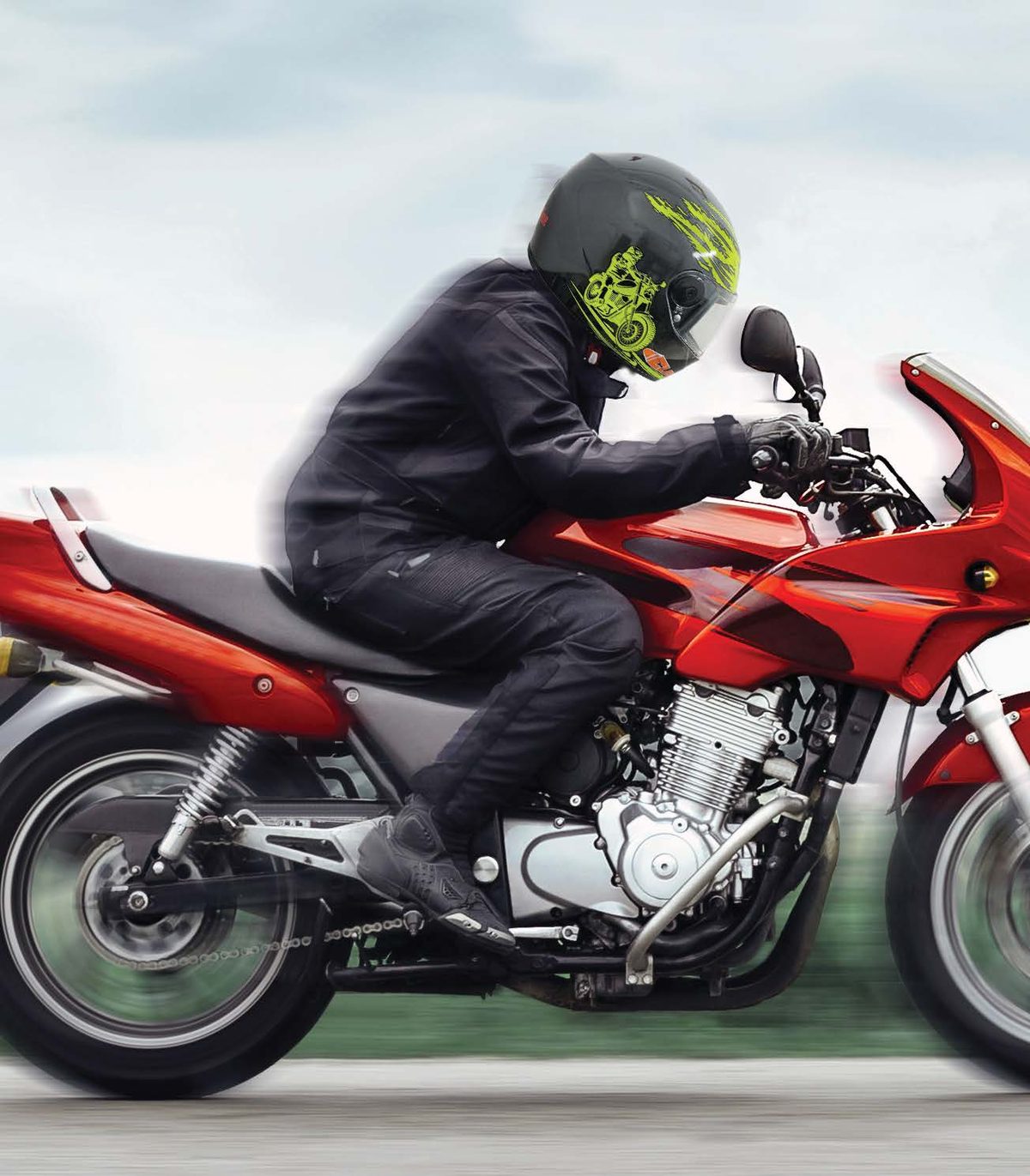 Rider leaning into a corner on a sport bike wearing an Axellise Storm Rider helmet
